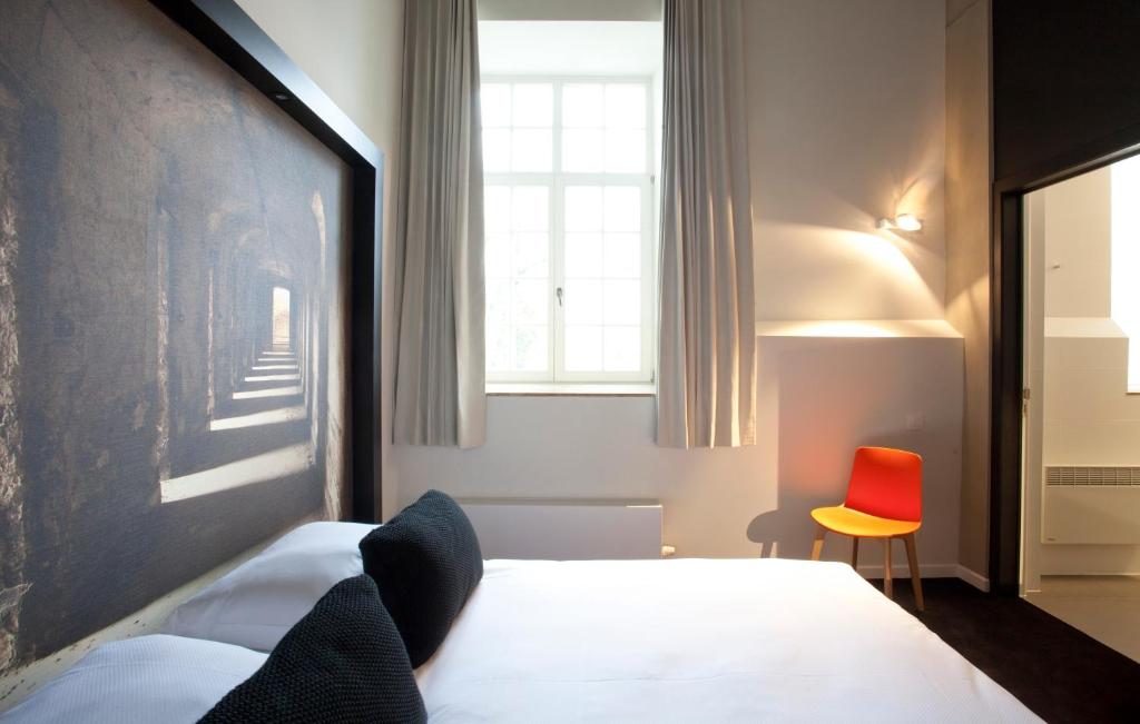 Postel nebo postele na pokoji v ubytování Hotel The Lodge Vilvoorde