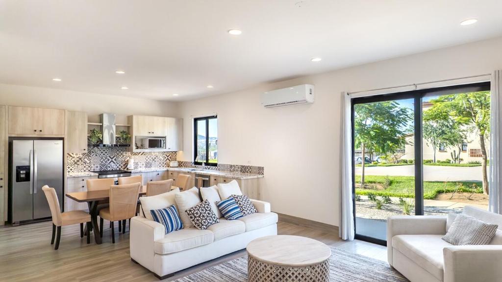 a living room with a couch and a table at Stunning 2BR Condo - 5 Min to Beach in Cabo San Lucas