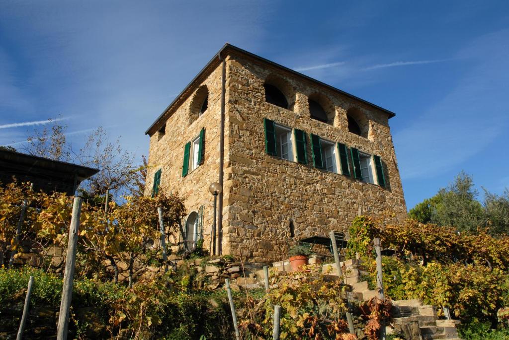 a brick building with windows on the side of it at Terre Bianche Appartamenti in Dolceacqua