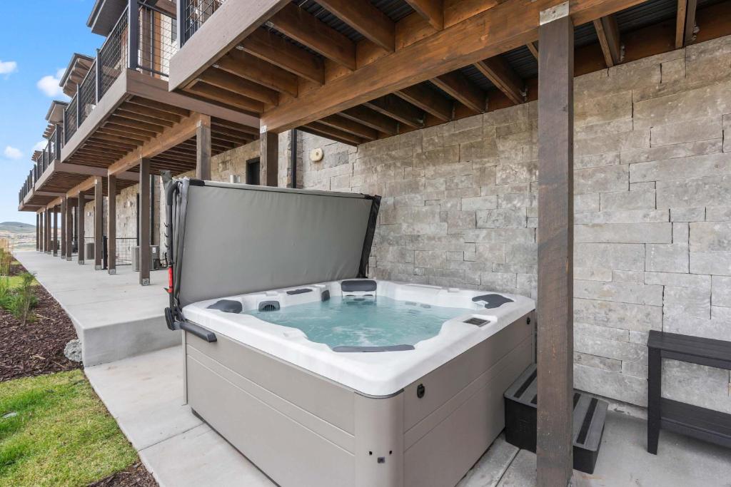 a jacuzzi tub on the side of a house at Jordanelle Express Gondola Condo 3 BR Hot Tub in Cranmer