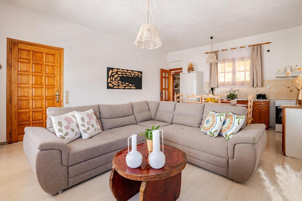 a living room with a couch and a table at Querencia Residence in Khánia