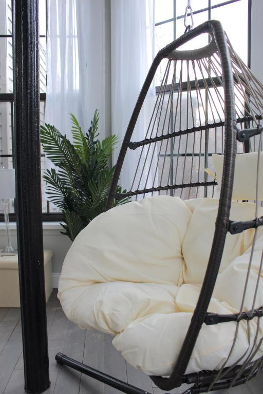 a swing chair in a living room with a white couch at Beautiful 2 BED 2 BATH Soaker Tub in Albany
