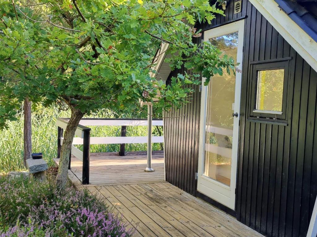 a wooden walkway leading to a house with a door at 6 person holiday home in Stege in Tyrholm