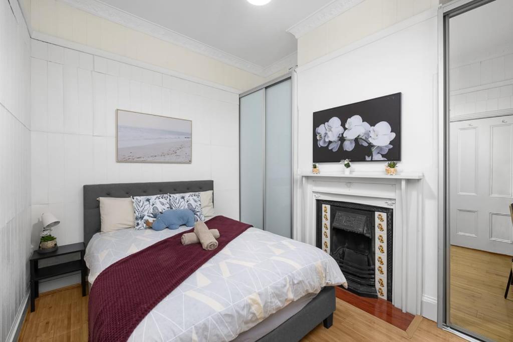 a bedroom with a bed with a teddy bear on it at Elegant Double Room Lidcombe - Close to Transport & Shops - Shared Bathroom in Rookwood Station