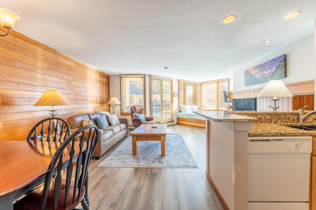 a kitchen and living room with a couch and a table at Lakeside 1489 by Summit County Mountain Retreats in Snake River Health Services Incorporated Heliport