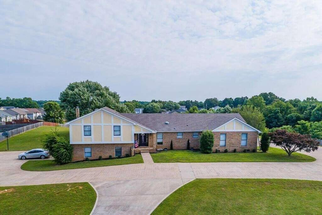 a large house with a car parked in a driveway at Magnolia in Clarksville