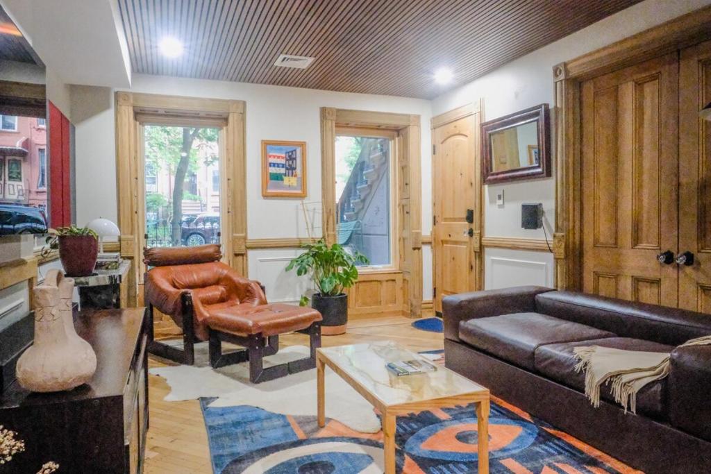 a living room with a couch and a table at Charming Garden Lvl Brownstone in Brooklyn
