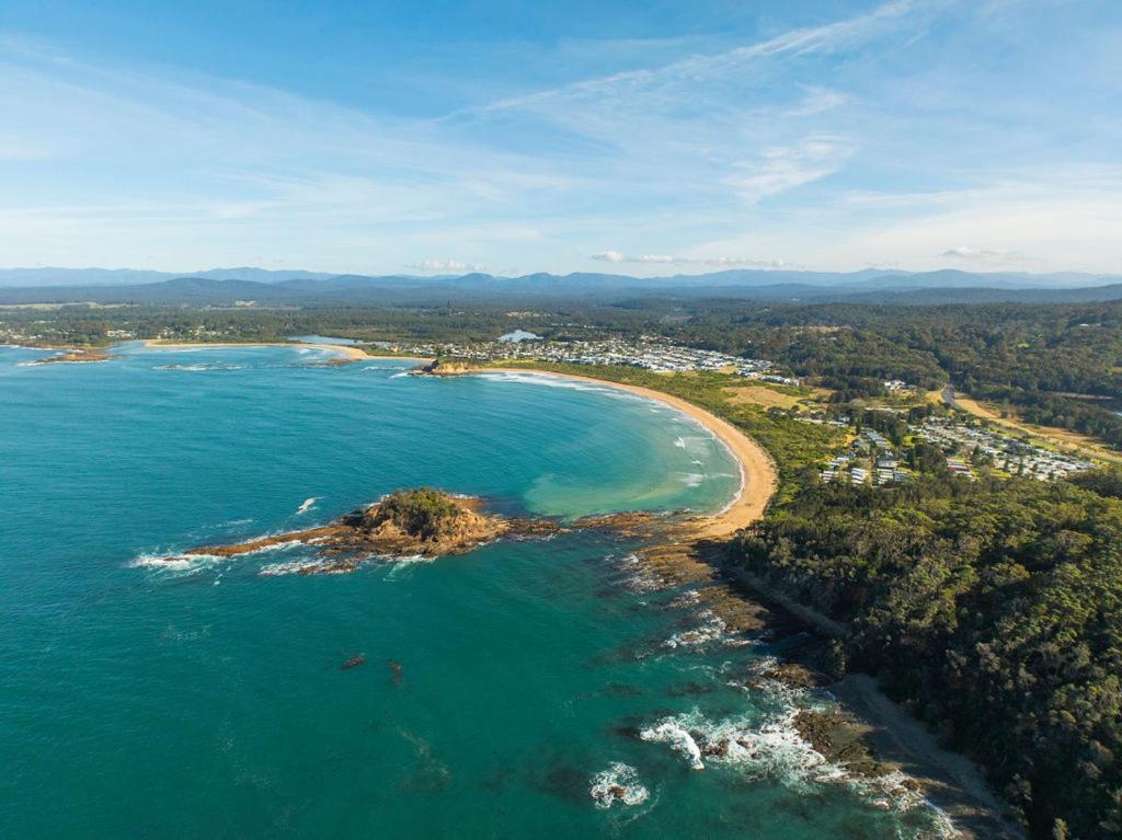 an aerial view of a beach and the ocean at Barlings Beach Holiday Park in Tomakin