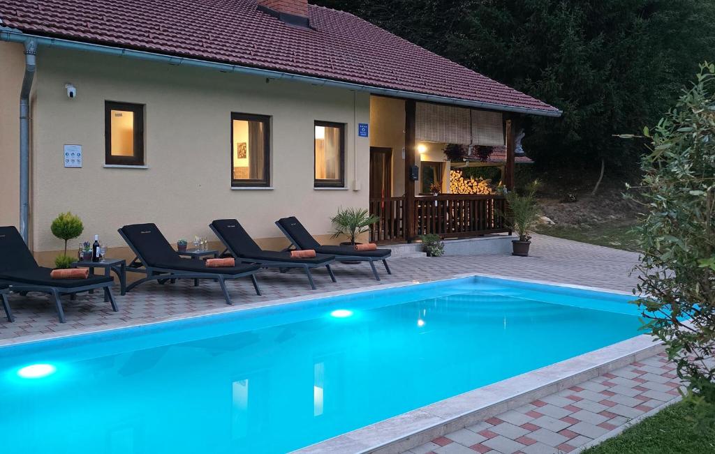 a swimming pool in front of a house at Lovely Home In Tuhelj With Sauna in Tuhelj