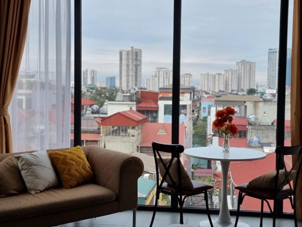 a living room with a couch and a table and a window at 29 Homestay Cầu Giấy in Hanoi