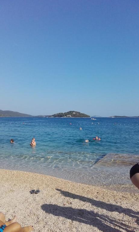 a group of people in the water at the beach at Apartments Ajka in Tisno