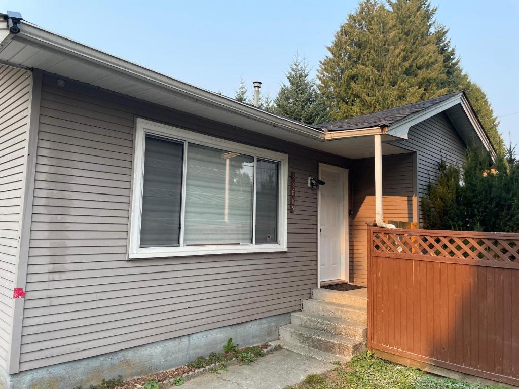 a house with a wooden fence and a gate at Central Vally Private House in Abbotsford