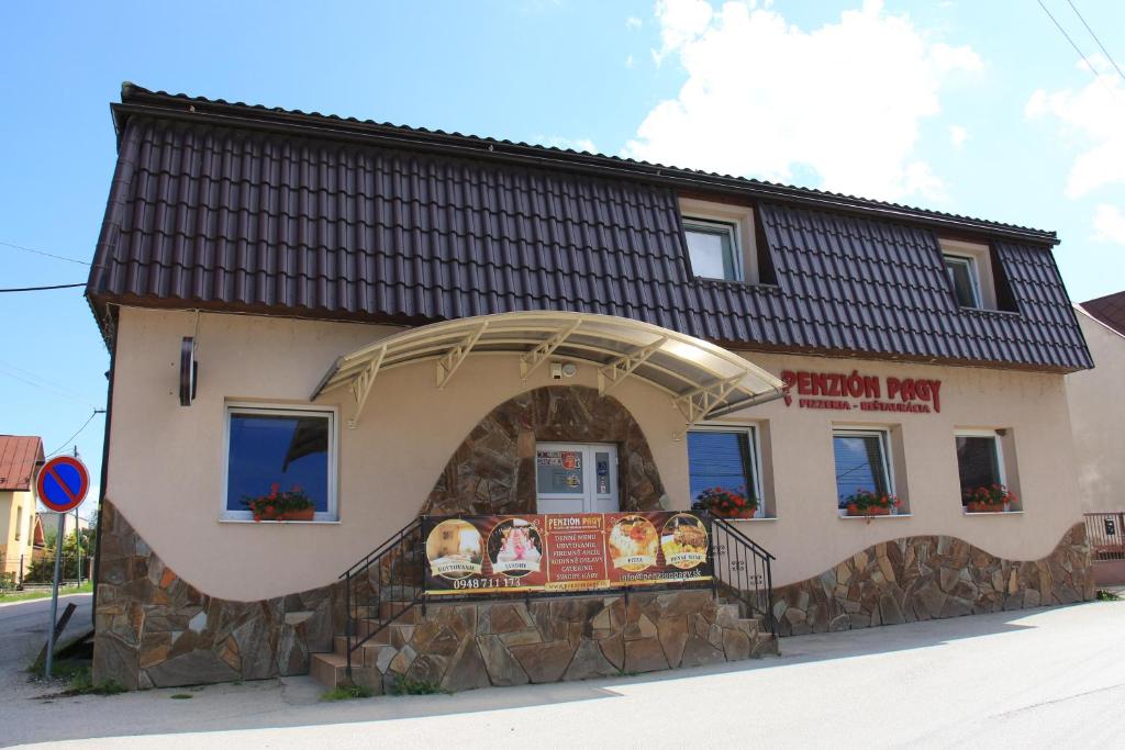 a small building with a sign in front of it at Penzión Pagy in Višňové