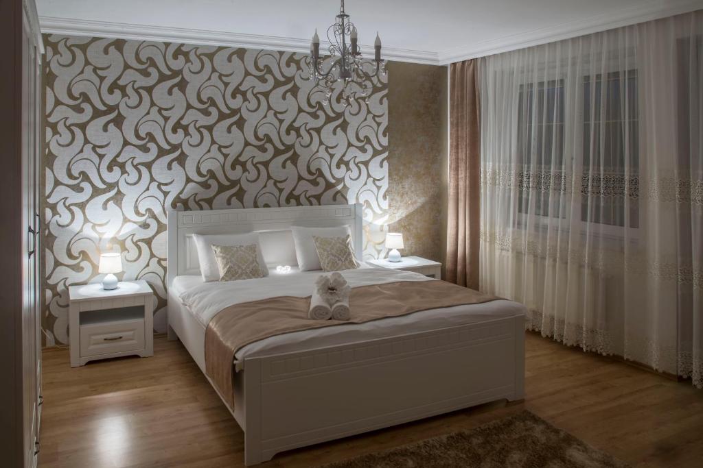 Postel nebo postele na pokoji v ubytování Villa Grande - Apartmány