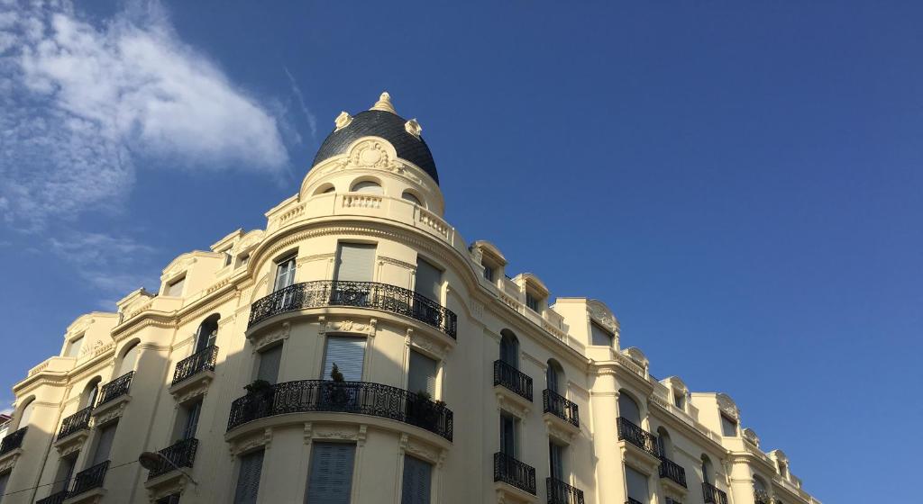 a tall white building with a cone top at Palais Sapho Residence in Nice