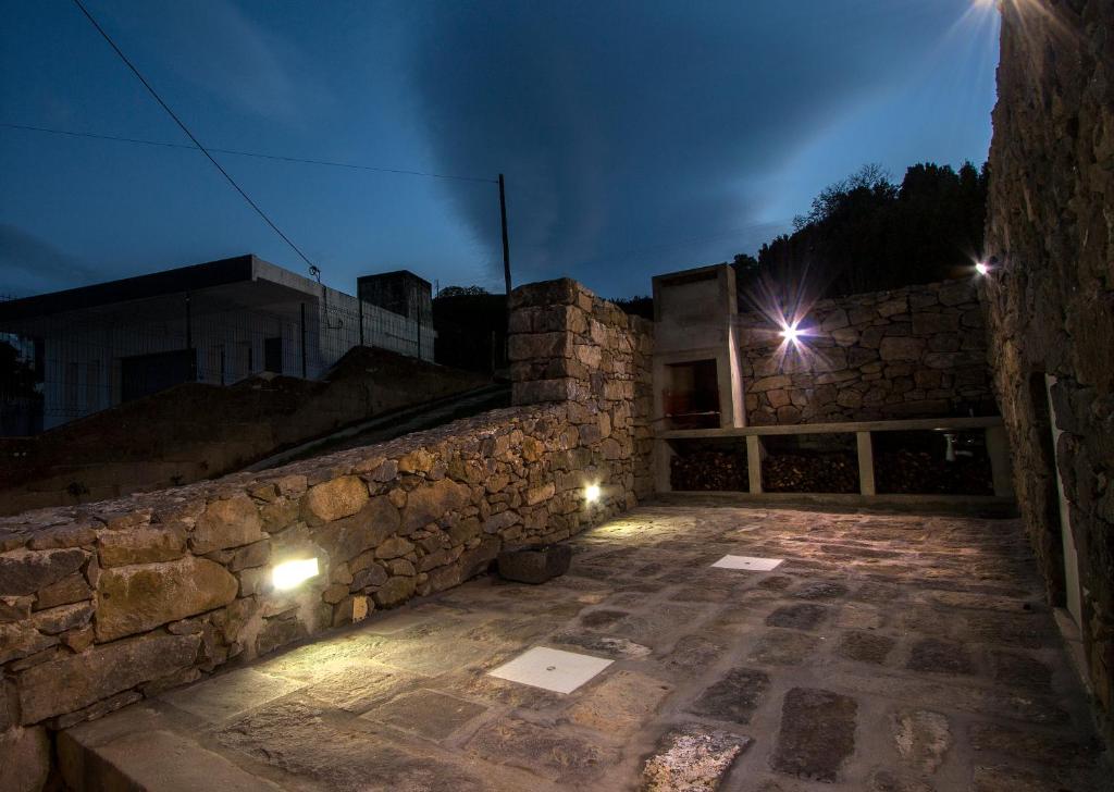 a stone building with two lights on it at night at Casa do Simão in Nordeste