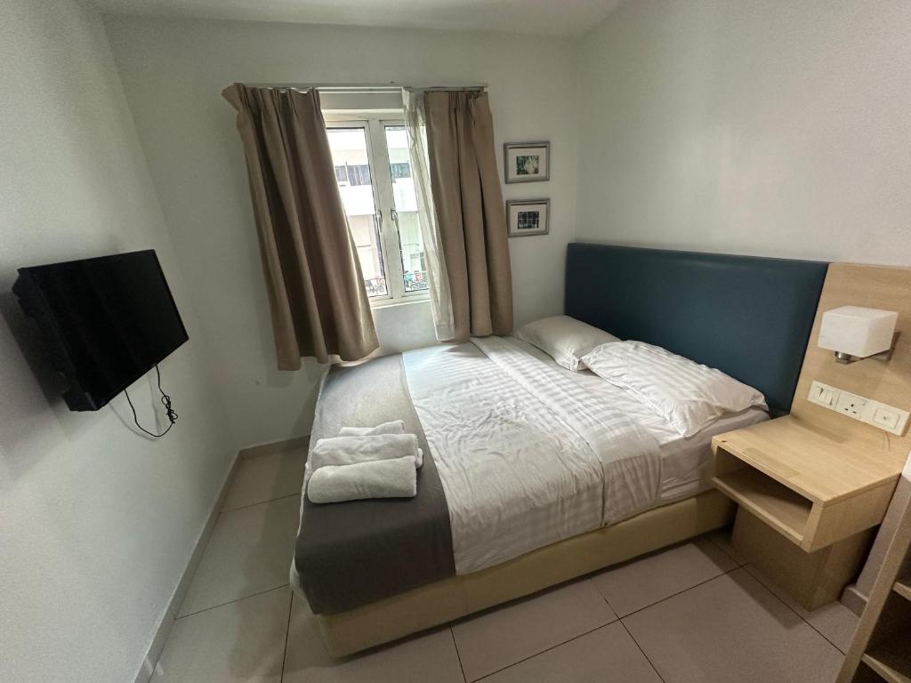 a small bedroom with a bed and a window at SS GREY INN Bb in Kuala Lumpur