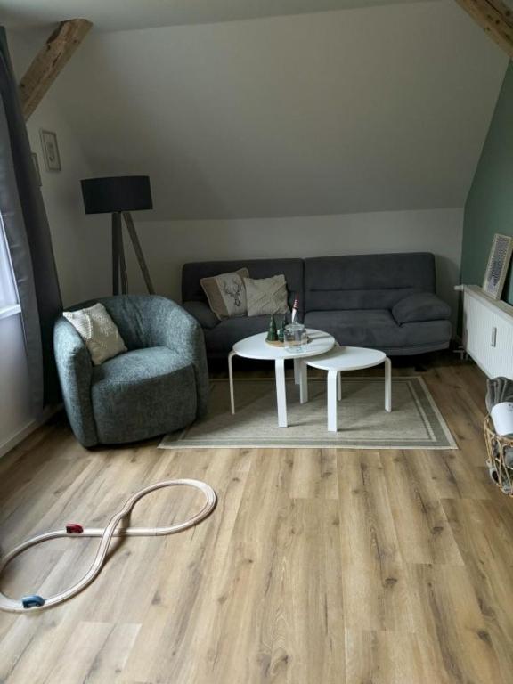 a living room with a couch and a table at Wurmbergblick Ferienwohnung in Braunlage