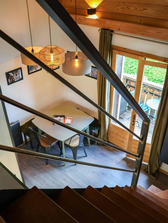 a view from the stairs of a room with a table at Genepi loft duplex 4 personnes in Arâches-la-Frasse