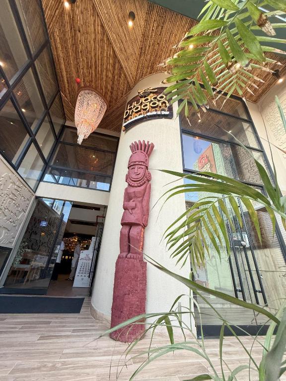 a building with a painting of a tower on the wall at Hotel Quincha y Adobe in Huanchaco