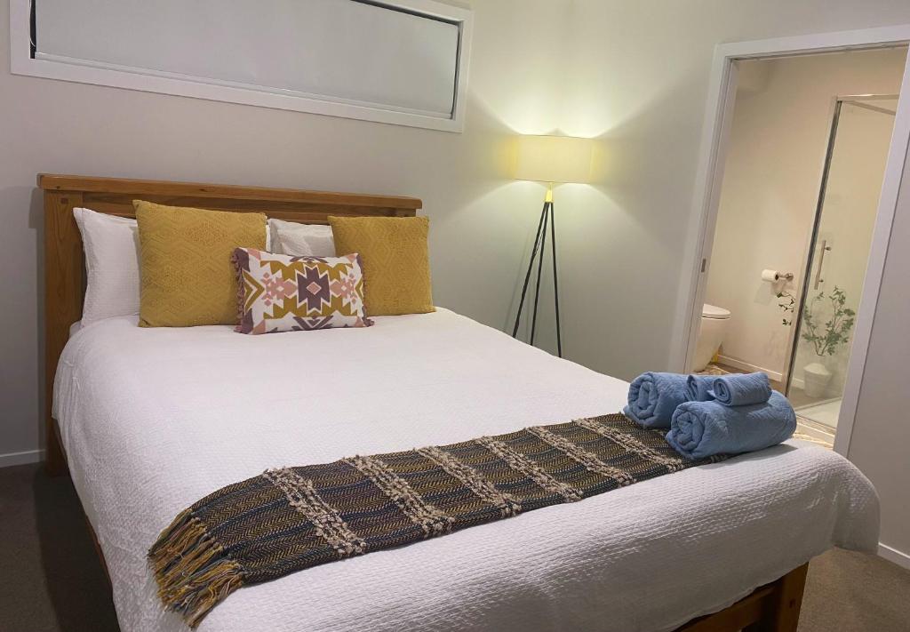 a bedroom with a bed with a stuffed animal on it at Bhujen Homestay in Te Awamutu