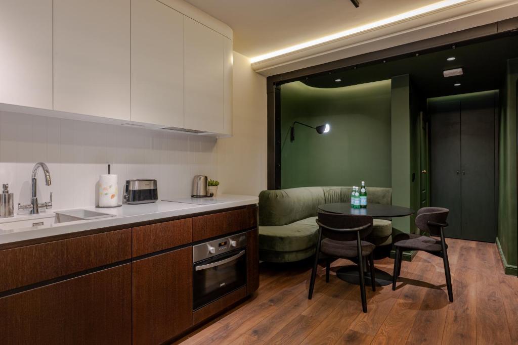 a kitchen with a table and a couch in a room at Private Premium Apartment in Plovdiv in Plovdiv