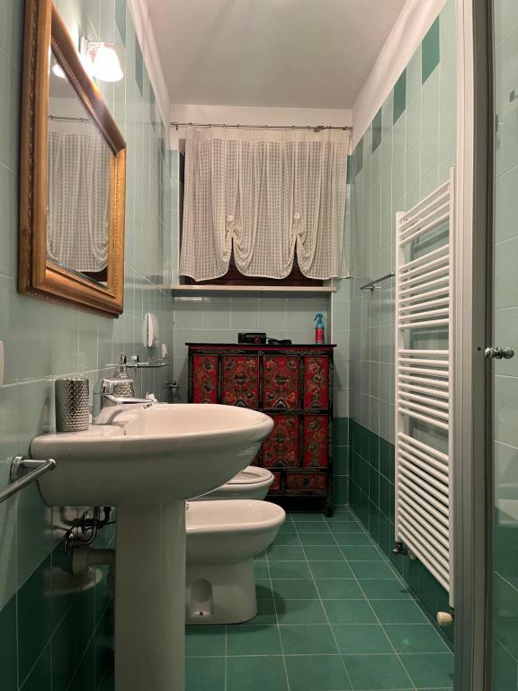 a bathroom with a sink and a toilet and a mirror at Chez Francois Lazise Pool in Lazise