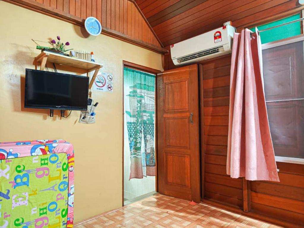 a room with a flat screen tv on a wall at Sekinchan 231 VA Chalet in Sekincan