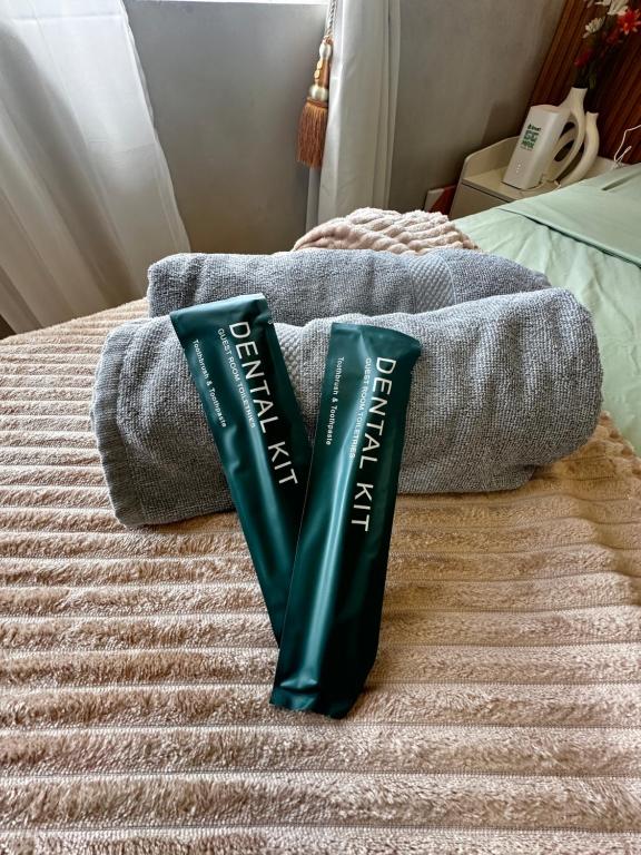 two green tubes sitting on top of a bed at WV Tower 2 Condo Sage Unit in Iloilo City