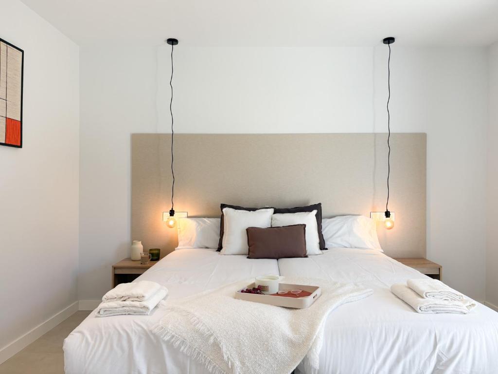 a bedroom with a white bed with a tray on it at TAYP Navalmoral in Navalmoral de la Mata