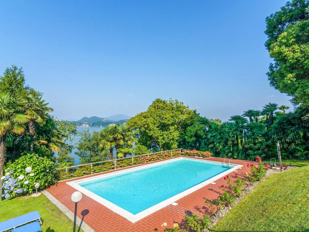 a swimming pool with a view of the water at Residenza Verde Lago in Stresa