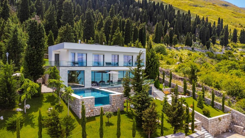 an aerial view of a house with a swimming pool at Horizon Villa Luxurious Lakefront Retreat in Široka