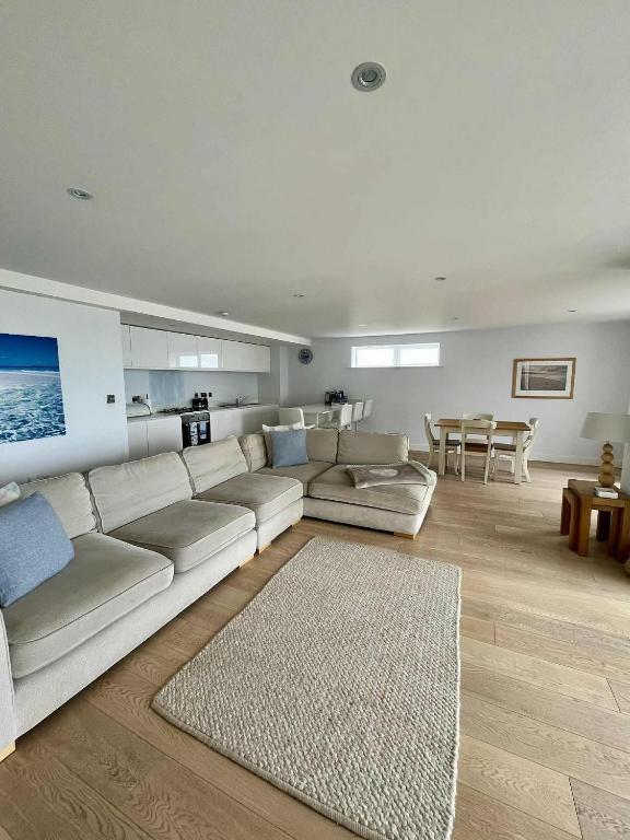 a living room with a white couch and a table at 6 Ocean Gate apartment in Newquay