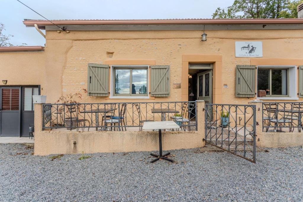 a building with a balcony with chairs on it at Maison Loustalet in Arzacq-Arraziguet