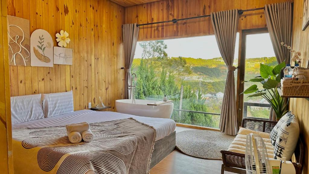 a bedroom with a bed and a tub and a window at Cloudy Hillside Botique - Homestay in Ấp Ða Lợi