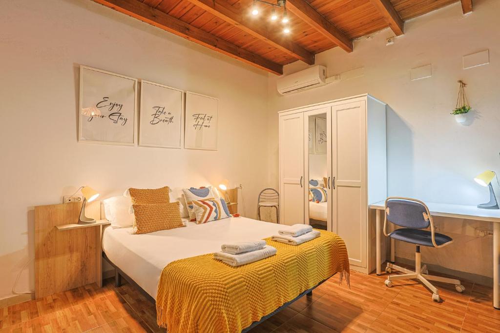 a bedroom with a bed and a desk and a chair at Loft B2, Apartment in Seville in Seville