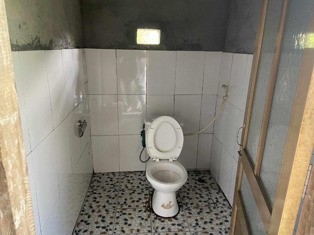 a bathroom with a toilet in a stall at Eco Homestay Family Room in Sa Pa