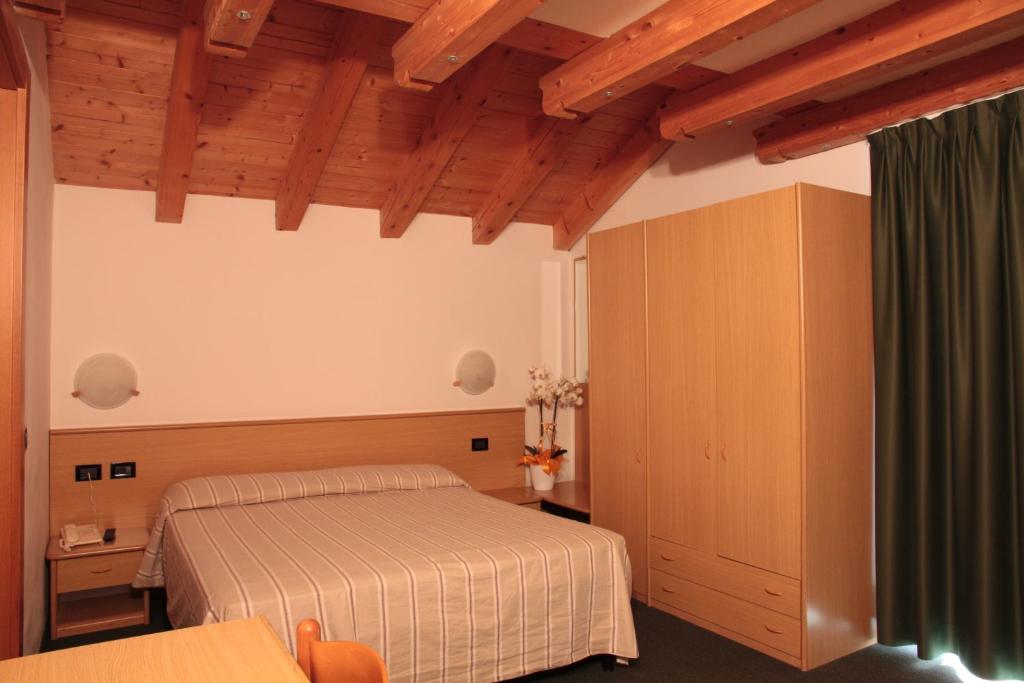 Postel nebo postele na pokoji v ubytování Albergo Miramonti