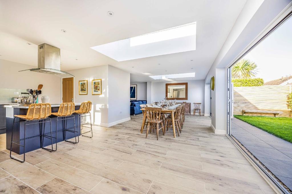 a kitchen and dining room with a table and chairs at Windrocks - Bracklesham Bay in Chichester