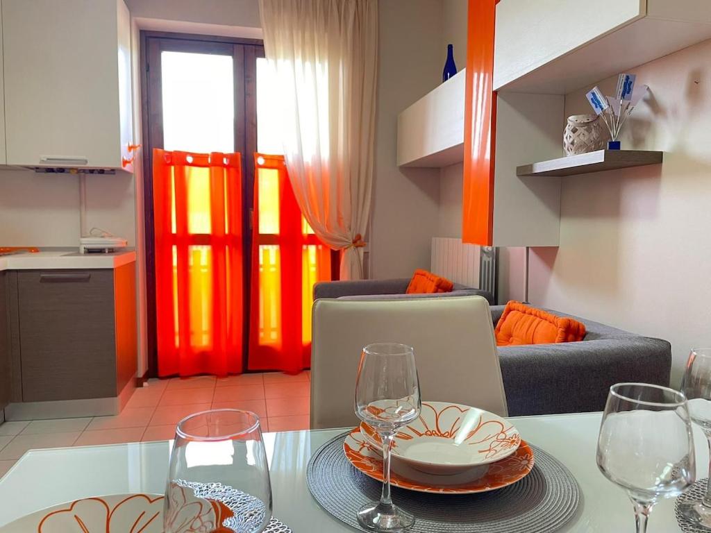 a living room with a table with wine glasses at Maison della Presolana in Songavazzo