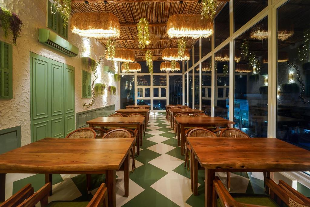 a row of tables and chairs in a restaurant at Sugar Stars Inn in Varanasi