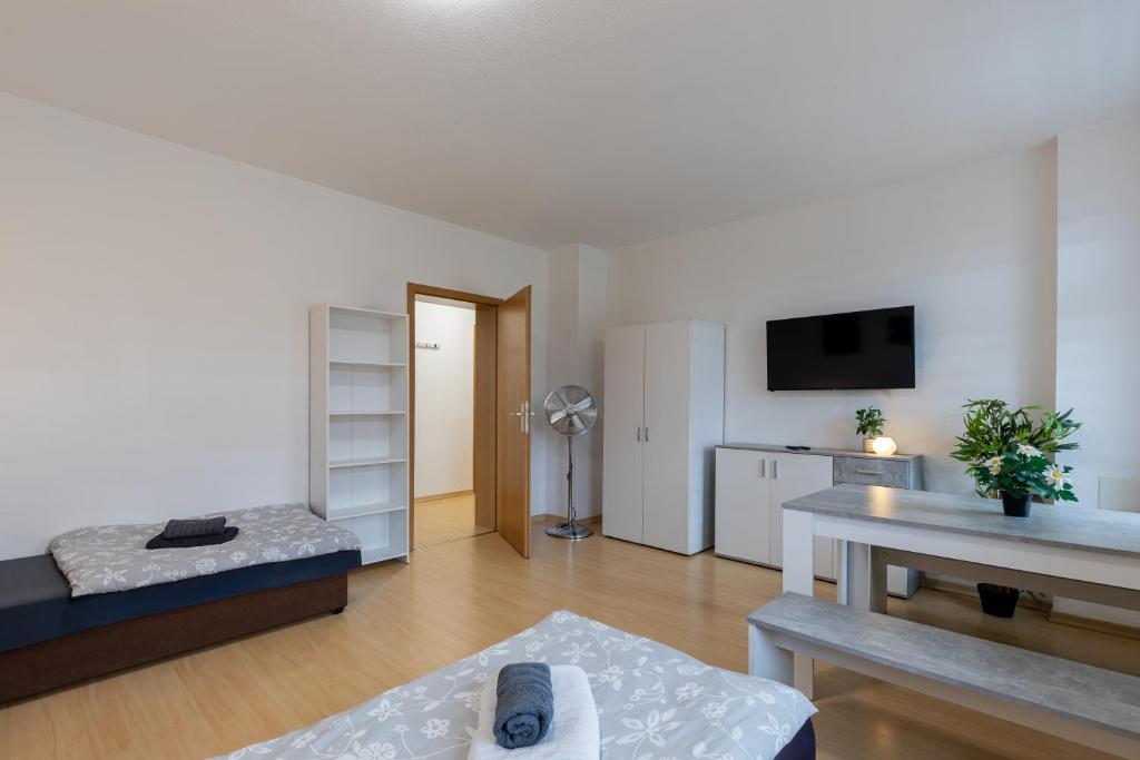 a living room with a couch and a table at FLEX Aparts - möblierte 2-Raum Wohnung in Zwickau in Zwickau