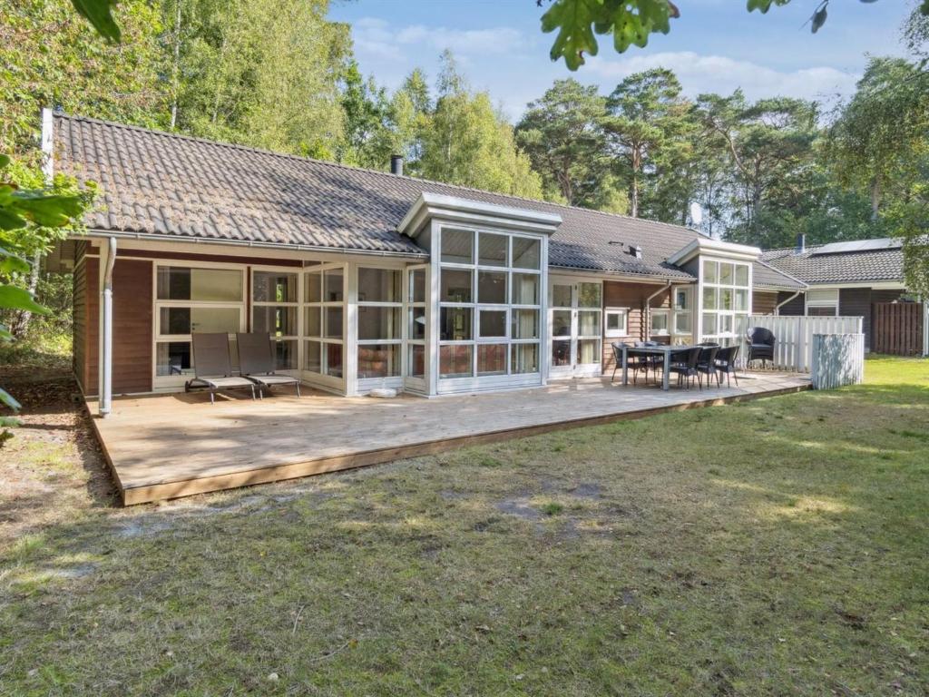 a house with a large deck in the yard at Holiday Home Dorit - 600m from the sea by Interhome in Hasle