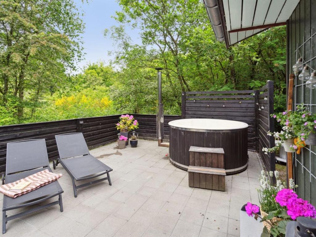a patio with a round table and chairs on a patio at Holiday Home Nyalle - 30km from the sea by Interhome in Toftlund