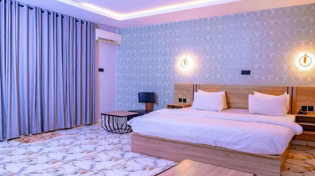 a bedroom with a large bed in a room at H3 Hotel and Events Centre in Abeokuta