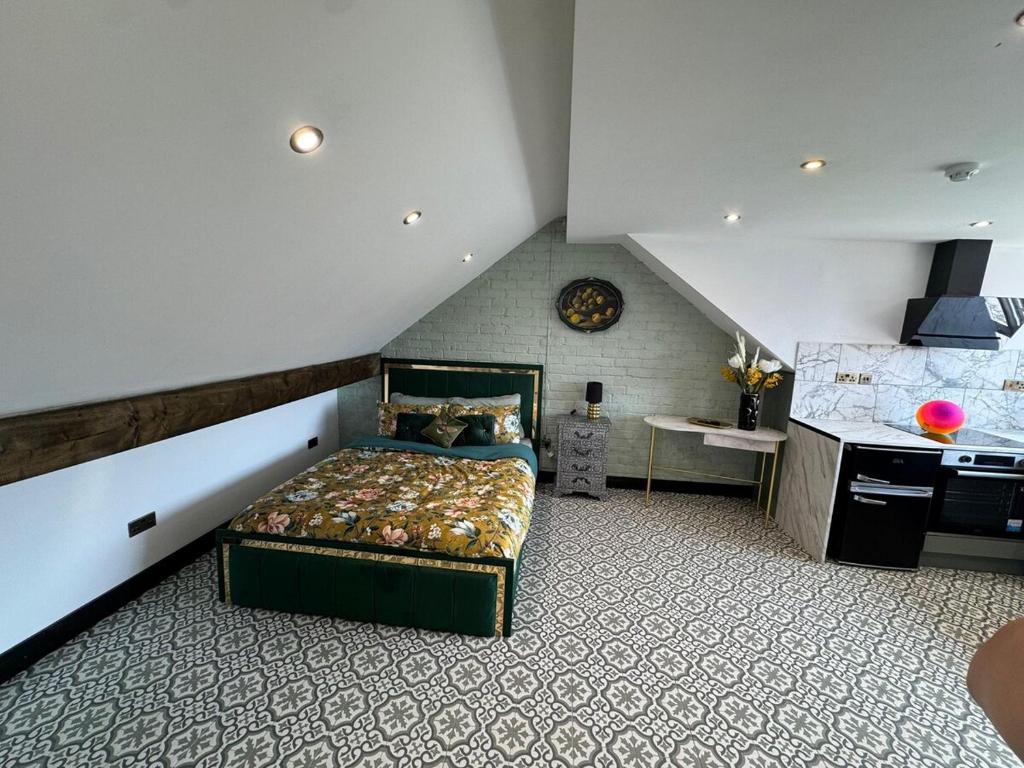 a bedroom with a bed in a attic at Green Gable Hideaway in Gloucestershire