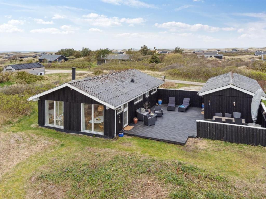 una vista dall'alto di una casa nera con un ponte di Holiday Home Zina - 600m from the sea by Interhome a Hjørring