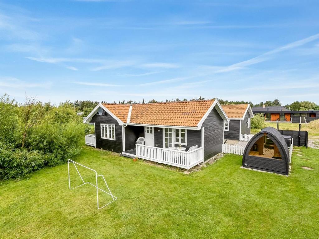a house with a soccer ball in the yard at Holiday Home Torhild - 700m from the sea by Interhome in Ringkøbing
