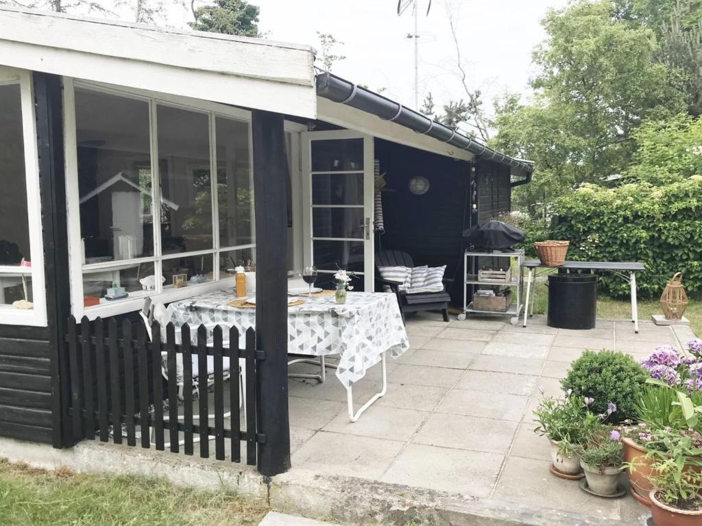 a patio with a table and some plants at Holiday Home Elisa - 600m from the sea by Interhome in Gedser