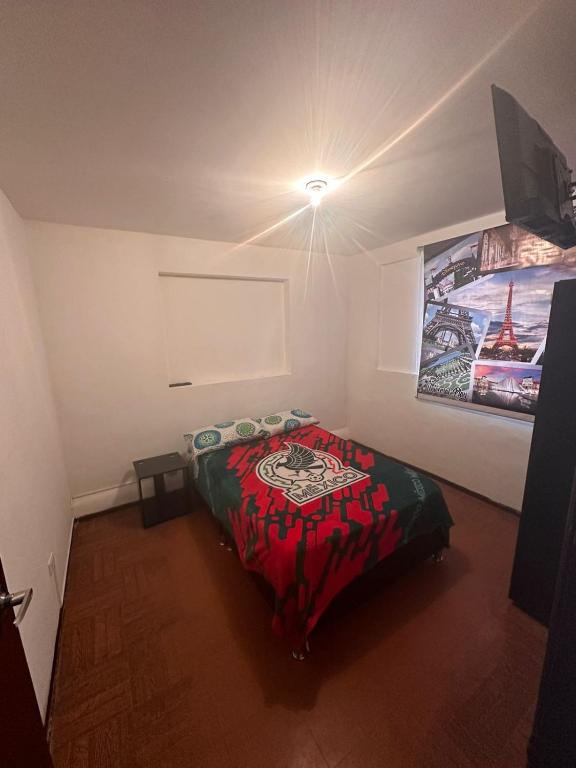 a bedroom with a bed and a painting on the wall at Universal Play in Bogotá